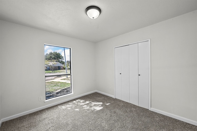 unfurnished bedroom with a closet and carpet floors