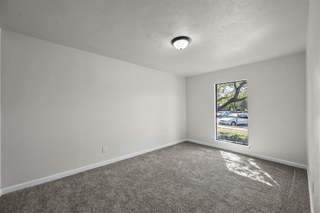 carpeted spare room featuring a textured ceiling