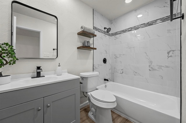 full bathroom with toilet, tiled shower / bath, vanity, and wood-type flooring