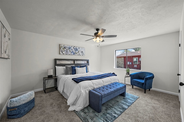 bedroom featuring a textured ceiling, carpet flooring, and ceiling fan