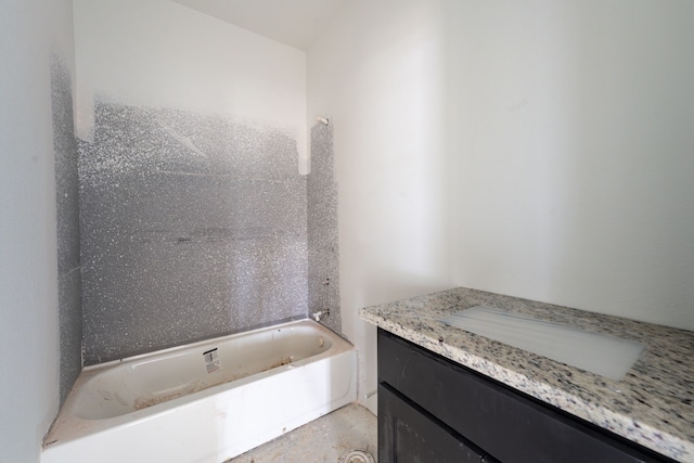 bathroom featuring a tub to relax in and vanity