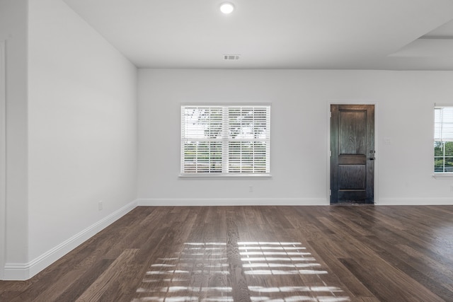 unfurnished room featuring recessed lighting, baseboards, visible vents, and dark wood-style floors