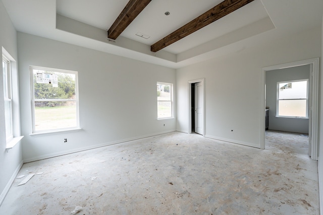 empty room featuring beam ceiling