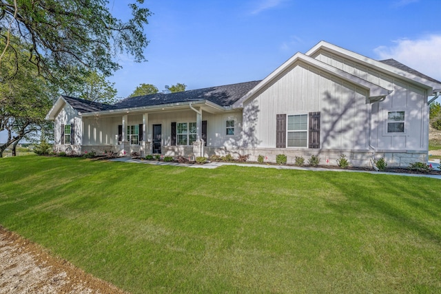 view of front of home with a porch and a front lawn