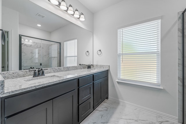 full bath featuring a marble finish shower, a sink, baseboards, visible vents, and marble finish floor