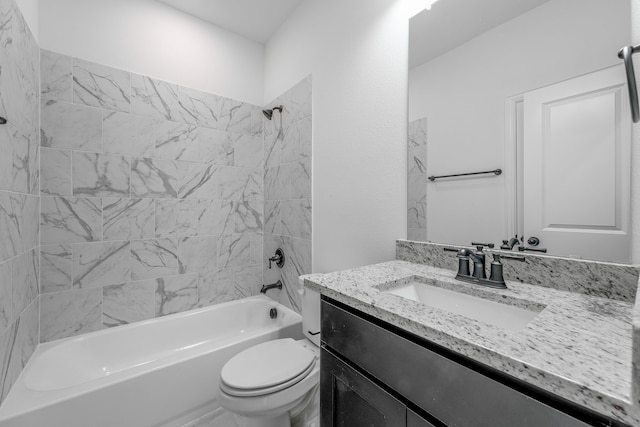 bathroom featuring toilet, vanity, and shower / tub combination