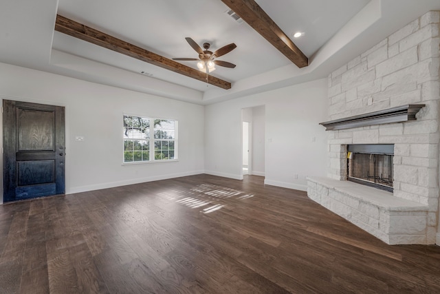 unfurnished living room featuring dark wood-style floors, baseboards, beamed ceiling, a ceiling fan, and a fireplace