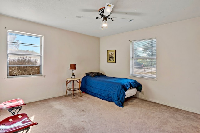 bedroom with light carpet and ceiling fan