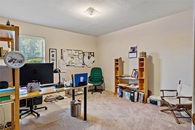 carpeted office space featuring a textured ceiling