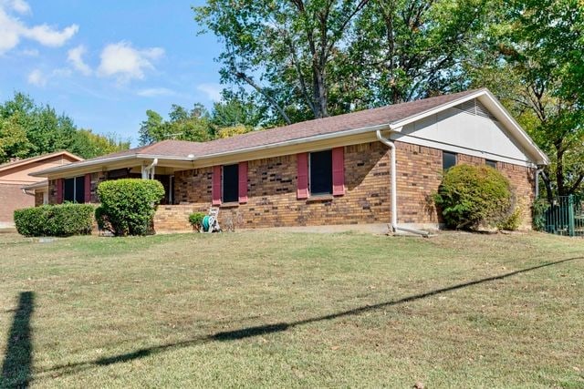 ranch-style house with brick siding and a front lawn
