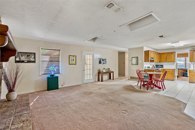 interior space with light carpet and a textured ceiling