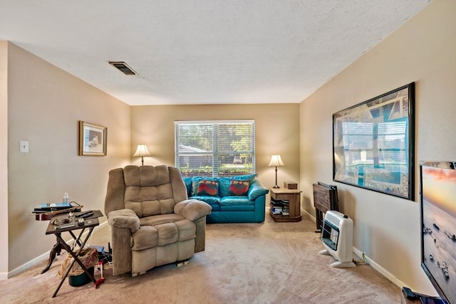 living area with visible vents, heating unit, baseboards, and light colored carpet