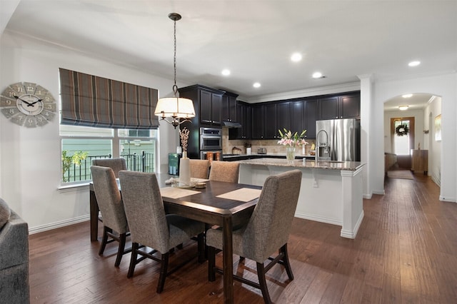 dining room featuring dark hardwood / wood-style flooring and ornamental molding