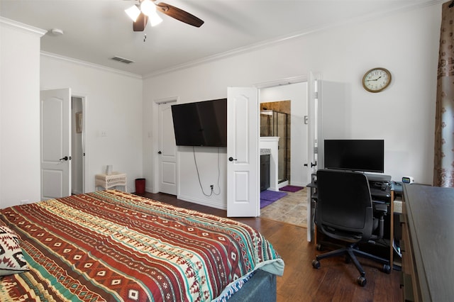 bedroom with ceiling fan, crown molding, dark wood-type flooring, and connected bathroom