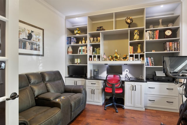 office with dark hardwood / wood-style flooring, built in desk, and crown molding