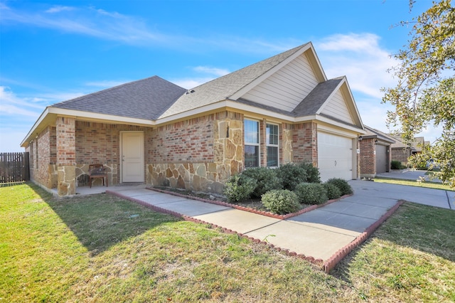 view of front of property featuring a garage and a front lawn