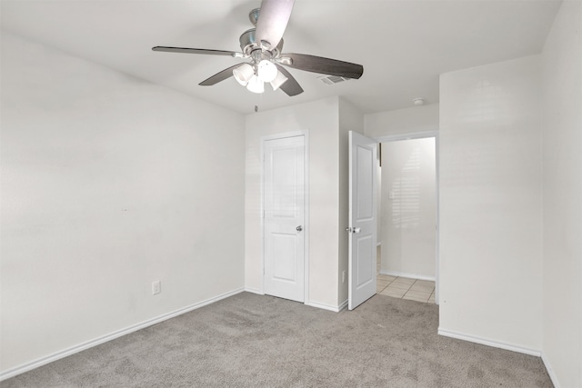 unfurnished bedroom with ceiling fan and light carpet