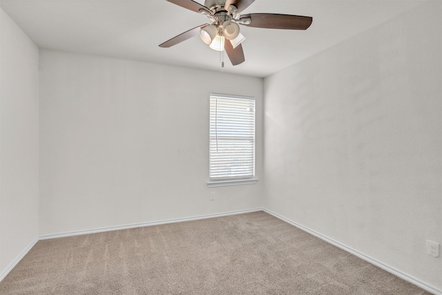 spare room with light colored carpet and ceiling fan