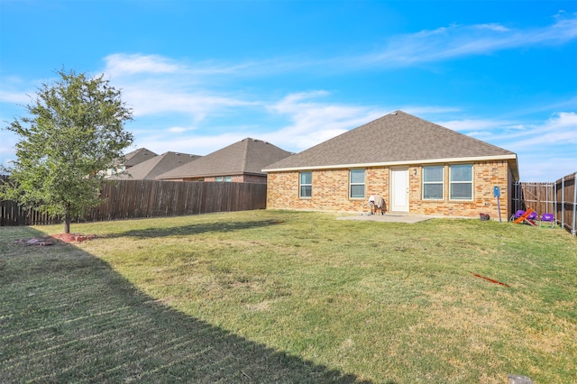 back of property with a patio area and a lawn