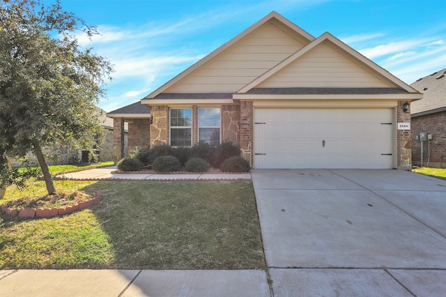 view of front of home with a front lawn and a garage