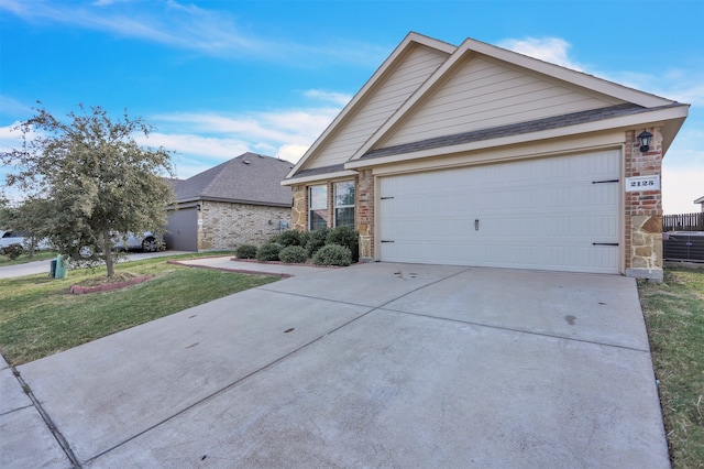 view of front of home with a front yard and a garage