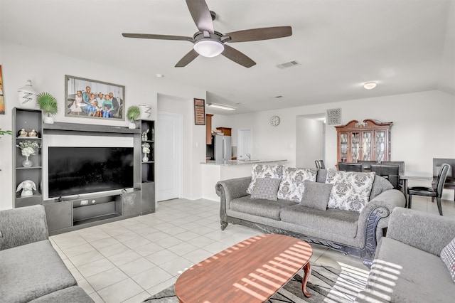 living room with ceiling fan and light tile patterned floors