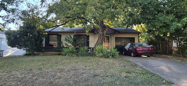 view of front of property with a garage and a front lawn