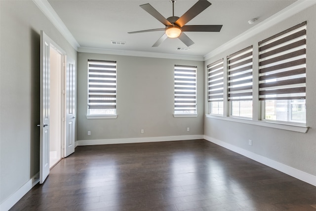 spare room with dark hardwood / wood-style flooring, crown molding, ceiling fan, and plenty of natural light