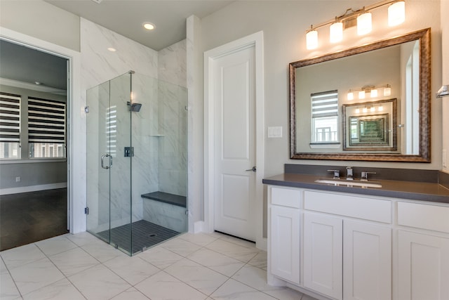 bathroom with vanity and a shower with shower door