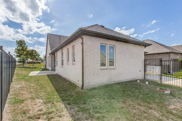 view of side of property with a lawn