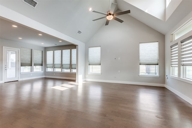 unfurnished living room featuring high vaulted ceiling, dark hardwood / wood-style flooring, and plenty of natural light