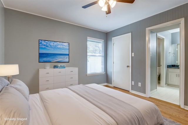 bedroom featuring ceiling fan, light hardwood / wood-style flooring, and ensuite bathroom