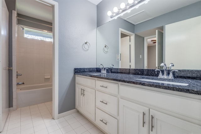 bathroom featuring vanity, tiled shower / bath, and tile patterned flooring