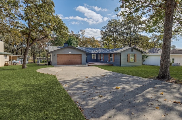 ranch-style home with a garage and a front lawn