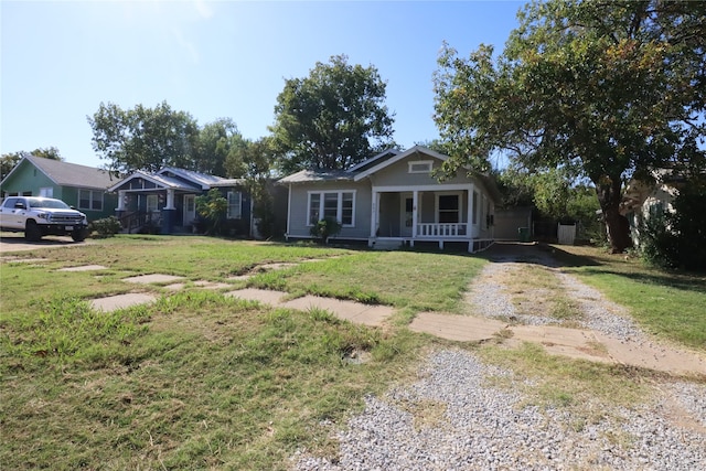 view of front of property with covered porch and a front yard