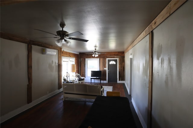 living room featuring dark hardwood / wood-style flooring, a wall unit AC, and wood walls