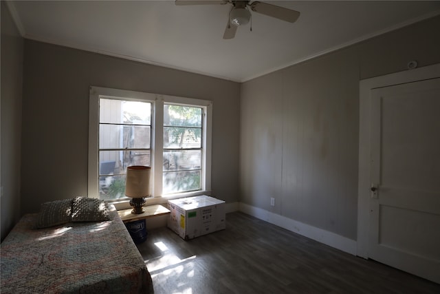 unfurnished bedroom featuring ornamental molding, ceiling fan, and dark hardwood / wood-style flooring