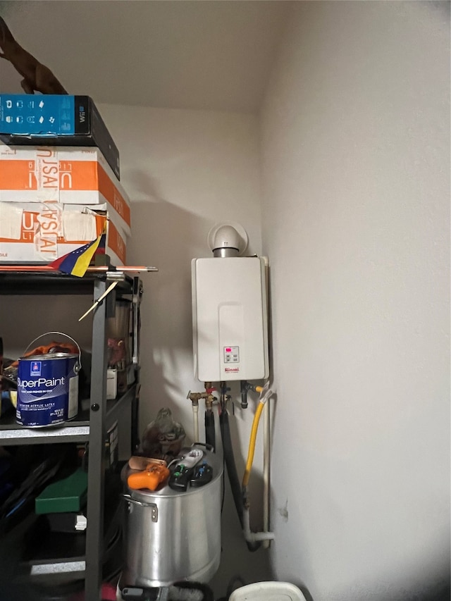 utility room featuring tankless water heater