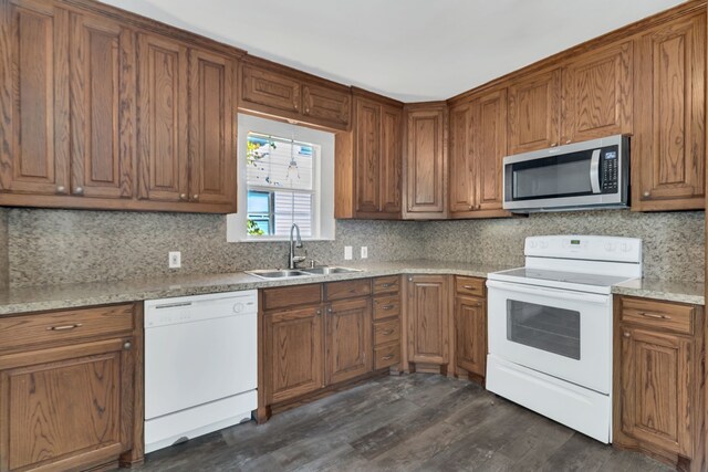 kitchen with sink, decorative backsplash, dark wood-type flooring, and white appliances