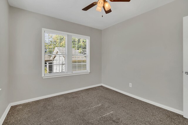 unfurnished room with dark colored carpet and ceiling fan