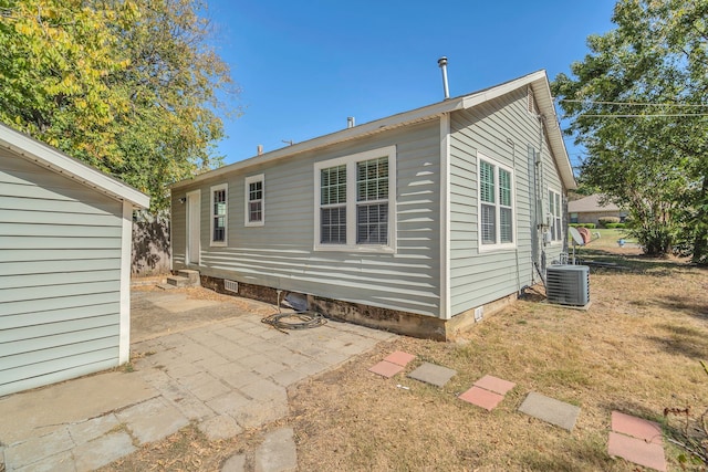 rear view of house featuring a patio area and cooling unit