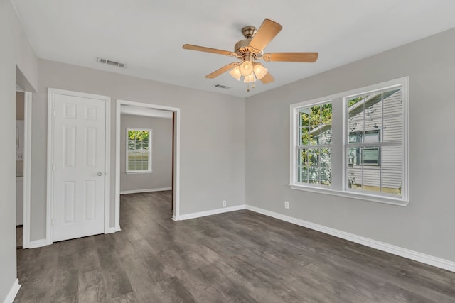 unfurnished room featuring ceiling fan and dark hardwood / wood-style floors