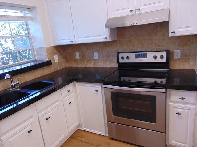 kitchen with sink, white cabinetry, stainless steel range with electric stovetop, and light wood-type flooring