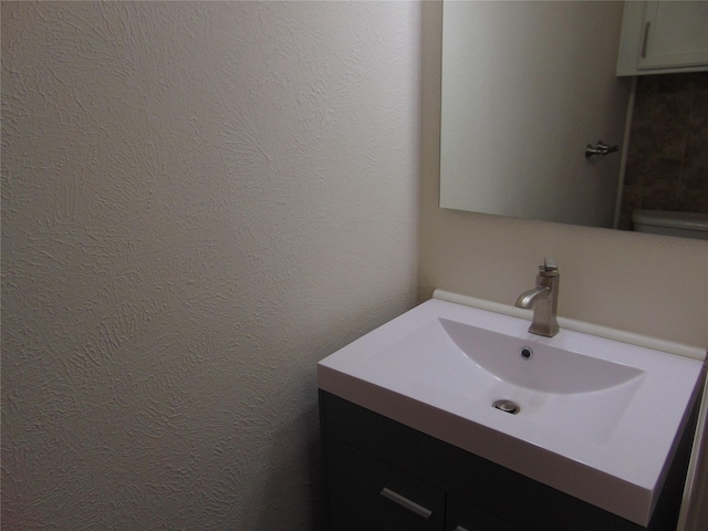 bathroom featuring toilet and vanity