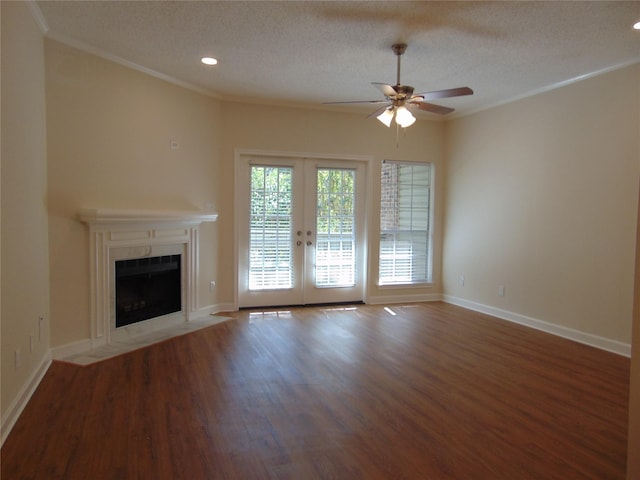 unfurnished living room with ornamental molding, french doors, a textured ceiling, and hardwood / wood-style floors