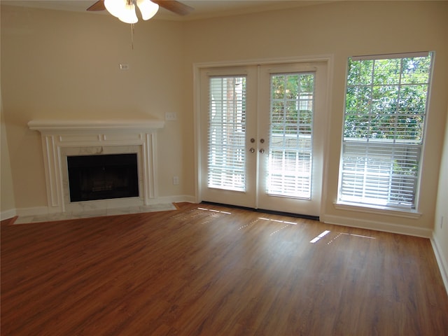 unfurnished living room with french doors, hardwood / wood-style flooring, and ceiling fan