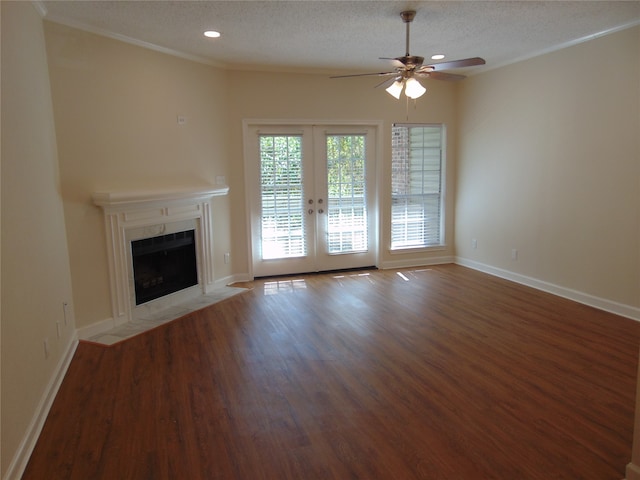 unfurnished living room featuring french doors, ceiling fan, hardwood / wood-style flooring, and a textured ceiling