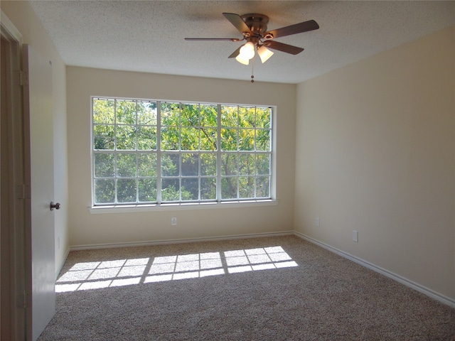 spare room with light carpet, a textured ceiling, and ceiling fan