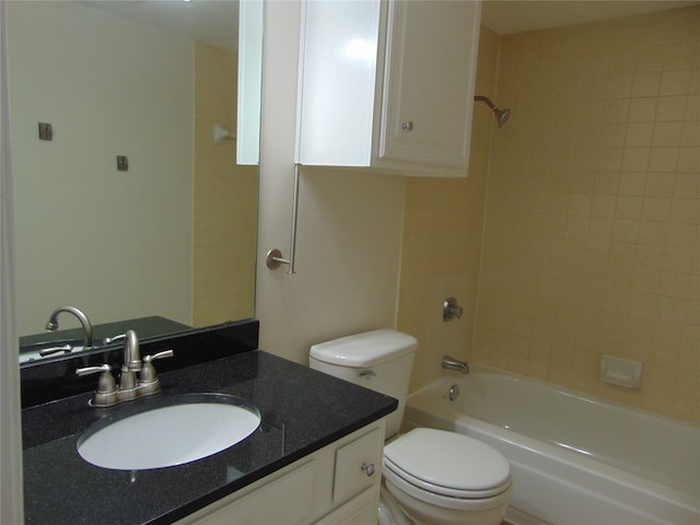 full bathroom with tiled shower / bath, vanity, and toilet