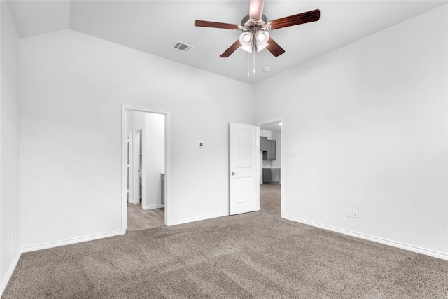 unfurnished bedroom with carpet, high vaulted ceiling, and ceiling fan